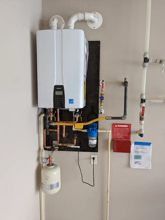 Professional plumber installing copper piping in a Port Washington home